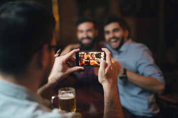 The guys in the pub are drinking beer