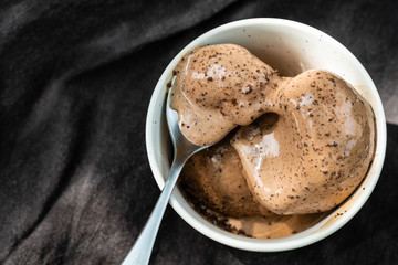 Bowl of chocolate ice cream on black  background.Top view