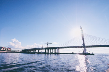 Fototapeta na wymiar Sunny day in Saint Petersburg. Big city bridge on Neva river.