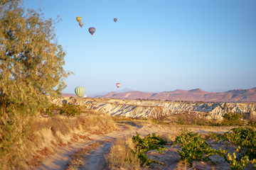 Travel and tourism by Turkey. Famous sightseeing Cappadocia, Anatolia. Beautiful landscape with mountains, caves and baloons in the sky.