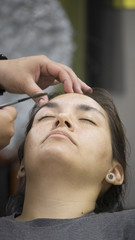 Obraz na płótnie Canvas young woman in beauty salon doing manicure