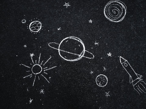 Chalk drawing. Space, planets and stars painted by children's. 
