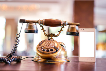 Connection concept. Analog and digital. Old fashioned telephone and modern smartphone on table.
