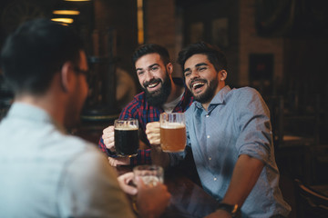 The guys in the pub are drinking beer