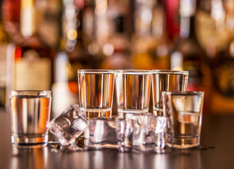 Traditional pure vodka in glasses on a black background, chilled drink