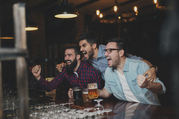 The guys in the pub are drinking beer