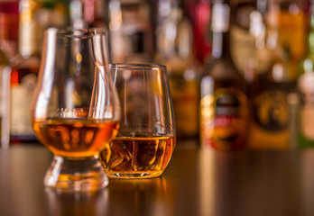 Scottish whisky in a glass with ice cubes, golden color whiskey