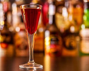 refreshing liqueur in a tall glass, alcoholic drink prepared by the bartender