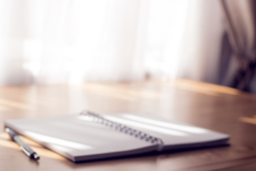 Notebook on a table. Blur background.