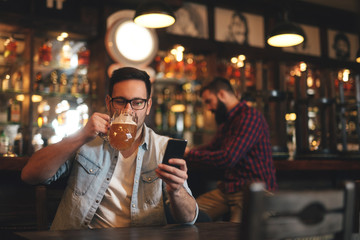 The guys in the pub are drinking beer