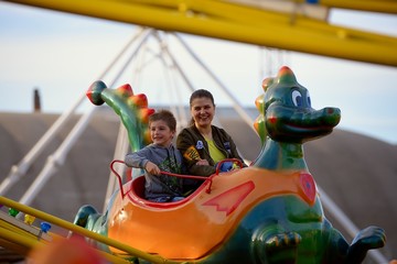 Mother and son ride on the Russian roller coaster