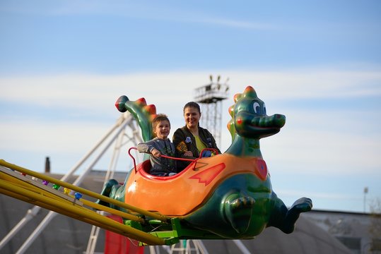 Mother and son ride on the Russian roller coaster