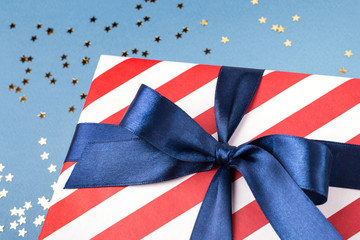 Close up view on gift box wrapped in national american colors. Holiday concept.