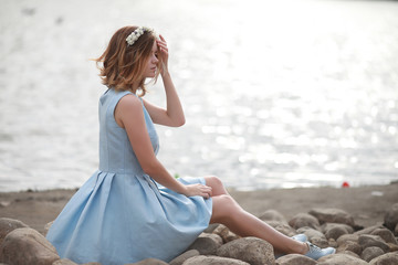 Girl in blue dress in green park