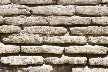 An ancient old rough drystone wall. Background photo. Texture pattern.