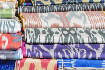 Traditional Uzbek asian silk. Colorful traditional uzbek xonatlas hon atlas textile fabric background image. Ornament Ikat Khan Atlas. Traditional uzbek material.