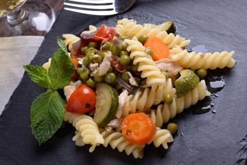 Slate plate with pasta and organic seasoning  
