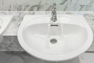 Modern faucet with wash basin sink counter marble wall bathroom interior contemporary