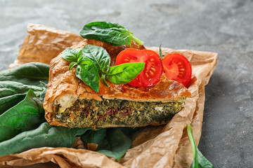 Piece of tasty pie with spinach on table