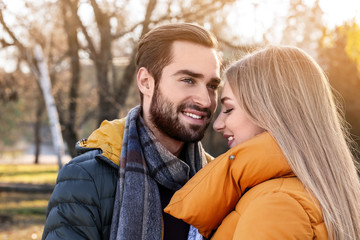 Portrait of young romantic couple outdoors