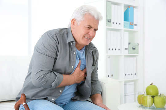 Senior Man Having Heart Attack On Sofa