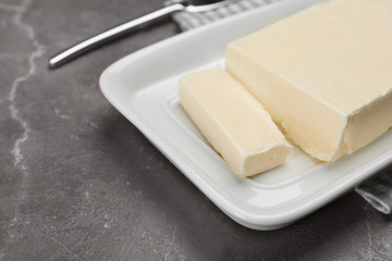 Plate with tasty fresh butter on table