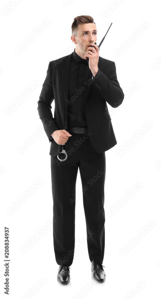 Wall mural male security guard using portable radio transmitter on white background