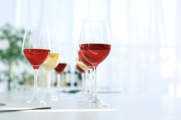Glasses with delicious wine on table indoors