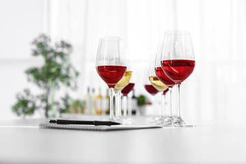 Glasses with delicious wine on table indoors