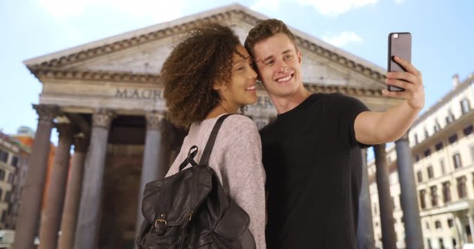 Happy and attractive couple take selfie in front of the Pantheon, Millennial male and female take picture together in Rome, 4k