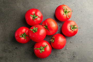 Fresh ripe tomatoes on grey background, top view