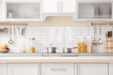 Fototapeta na wymiar Countertop and blurred view of kitchen interior on background