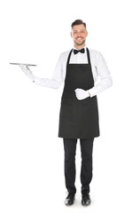 Handsome waiter with empty tray on white background