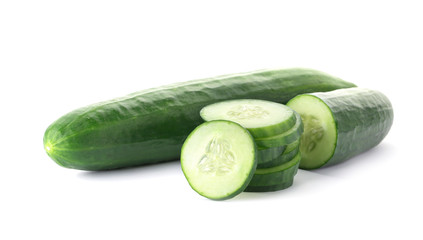Whole and sliced fresh cucumbers on white background