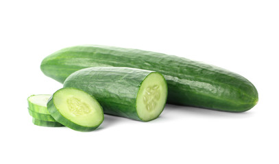 Whole and sliced fresh cucumbers on white background