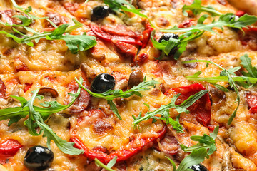 Delicious pizza with olives and sausages, closeup