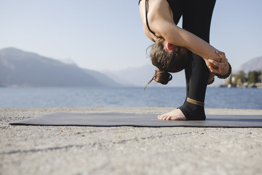 Woman doing Standing Forward Bend, Uttanasana