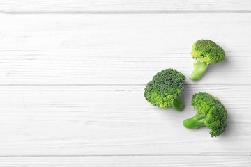 Fresh green broccoli on wooden background, top view