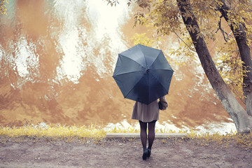 Young girl in a coat in autumn  park