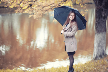 Young girl in a coat in autumn  park