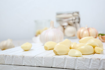 Fototapeta na wymiar Ripe garlic cloves on wooden board, closeup