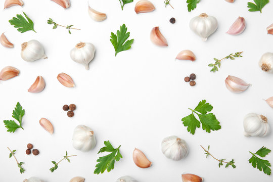 Flat lay composition with garlic on light background