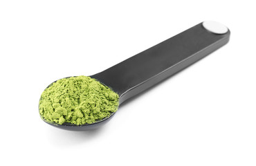 Spoon with powdered matcha tea on white background