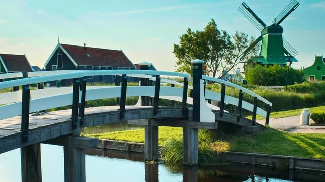 Bridge over canal at windmills at Zaanse Schans in Holland. Zaandam, Netherlands