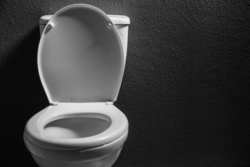 New ceramic toilet bowl on dark background