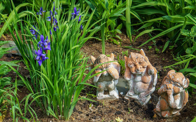 garden figures of animals representing the saying: see no evil, say no evil, hear no evil