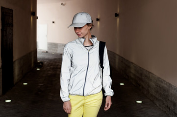 Sporty looking woman wearing reflective jacket and cap