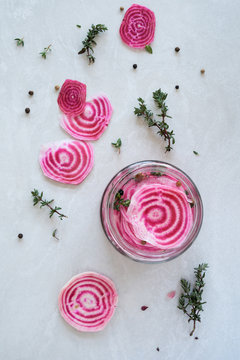 Overhead of candy striped beetroot sliced in pickling brine