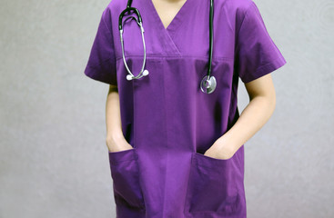 The doctor is wearing a purple gown.