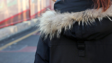 Back of woman in the street in winter.